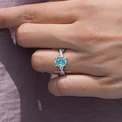 Sterling silver band with oval blue moissanite centerpiece and pave accents