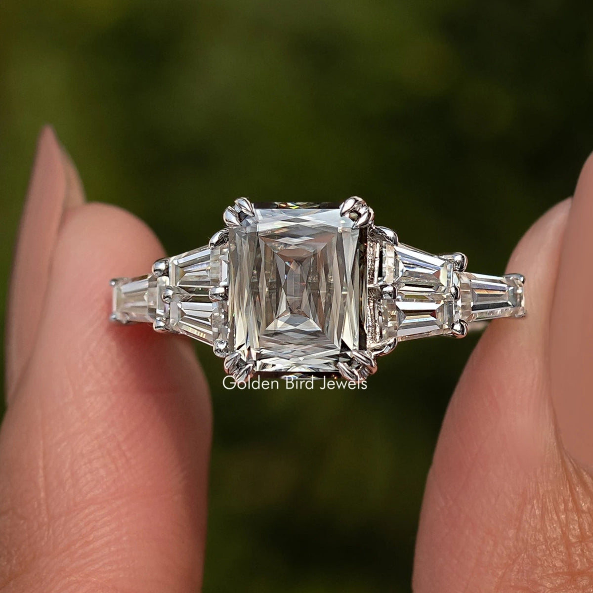 Sterling silver ring with rectangular step-cut center moissanite and baguette side stones