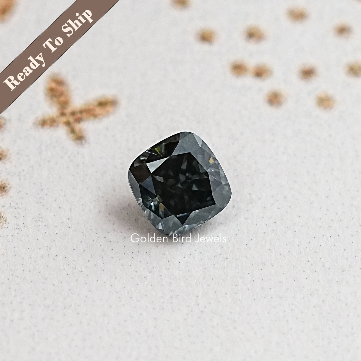 Cushion-cut moissanite gemstone in dark gray/black, rounded cushion facet pattern