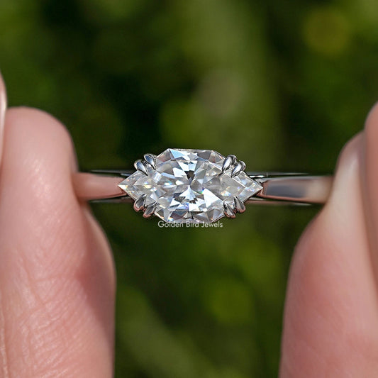Close-up marquise moissanite solitaire ring with prong setting on a silver band