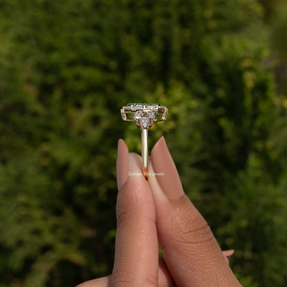 Blue moissanite oval engagement ring with round side stones, open gallery setting