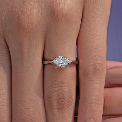 East-west marquise solitaire ring with clear center stone held by small prongs