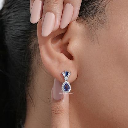 Blue pear-cut drop earrings with diamond halo and prong-set top, silver-tone