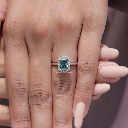 Sterling silver ring with emerald-cut blue moissanite center and diamond halo
