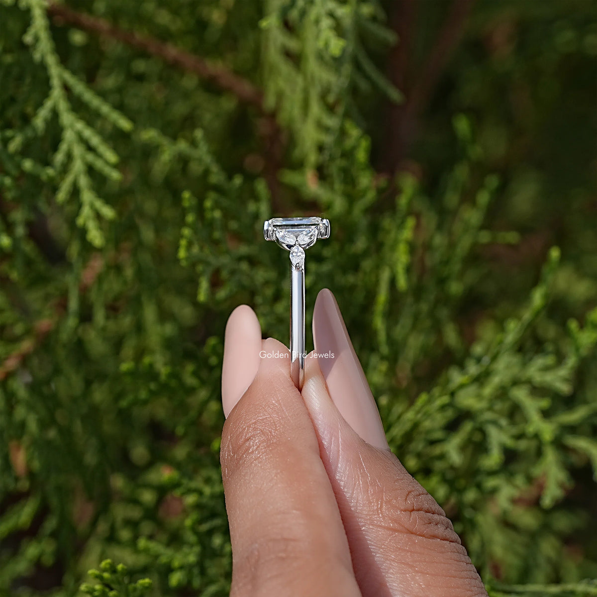 925 silver moissanite wedding ring with emerald-cut center stone on finger