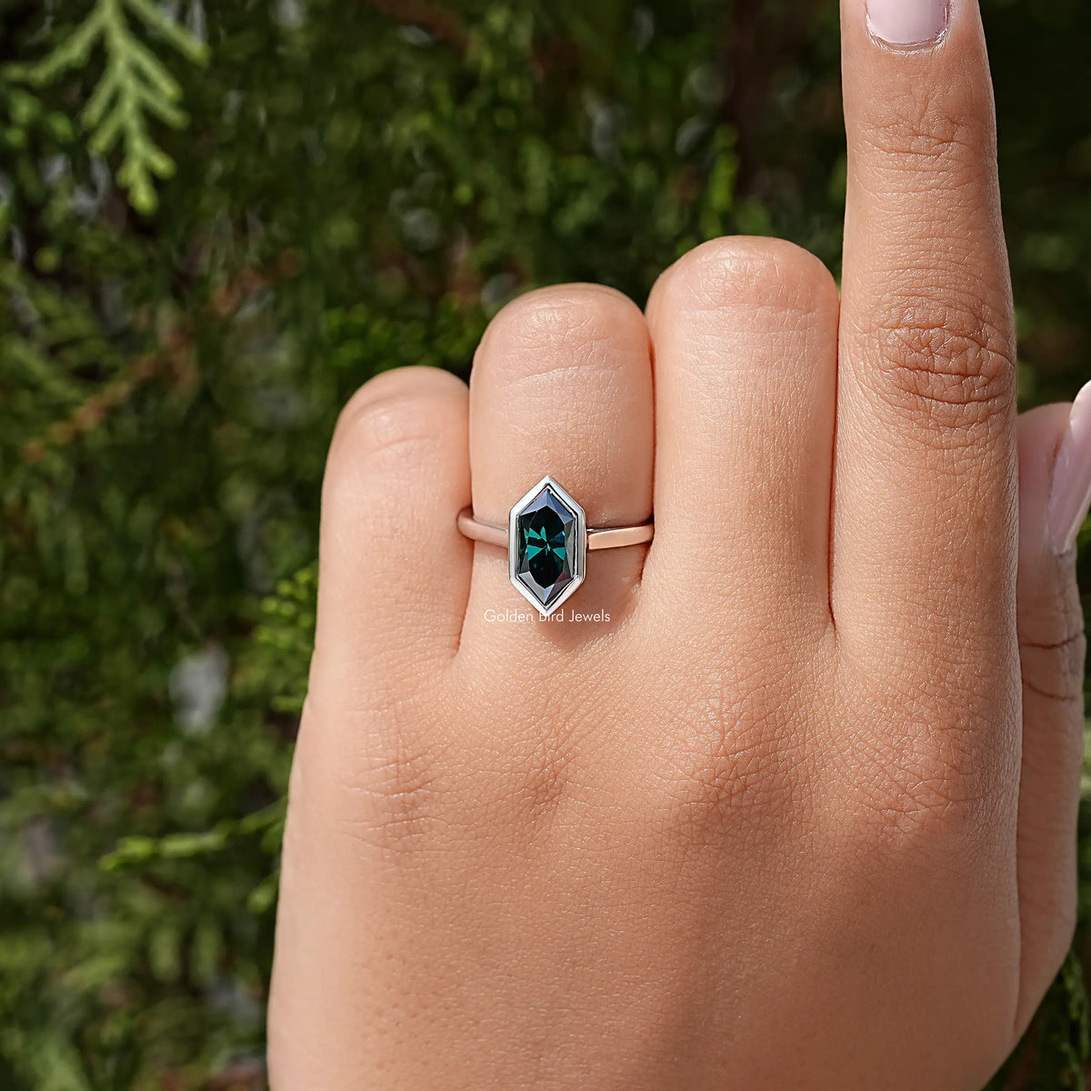 Sterling silver ring with green marquise bezel-cut gemstone, narrow band