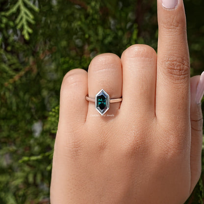 Sterling silver ring with green marquise bezel-cut gemstone, narrow band