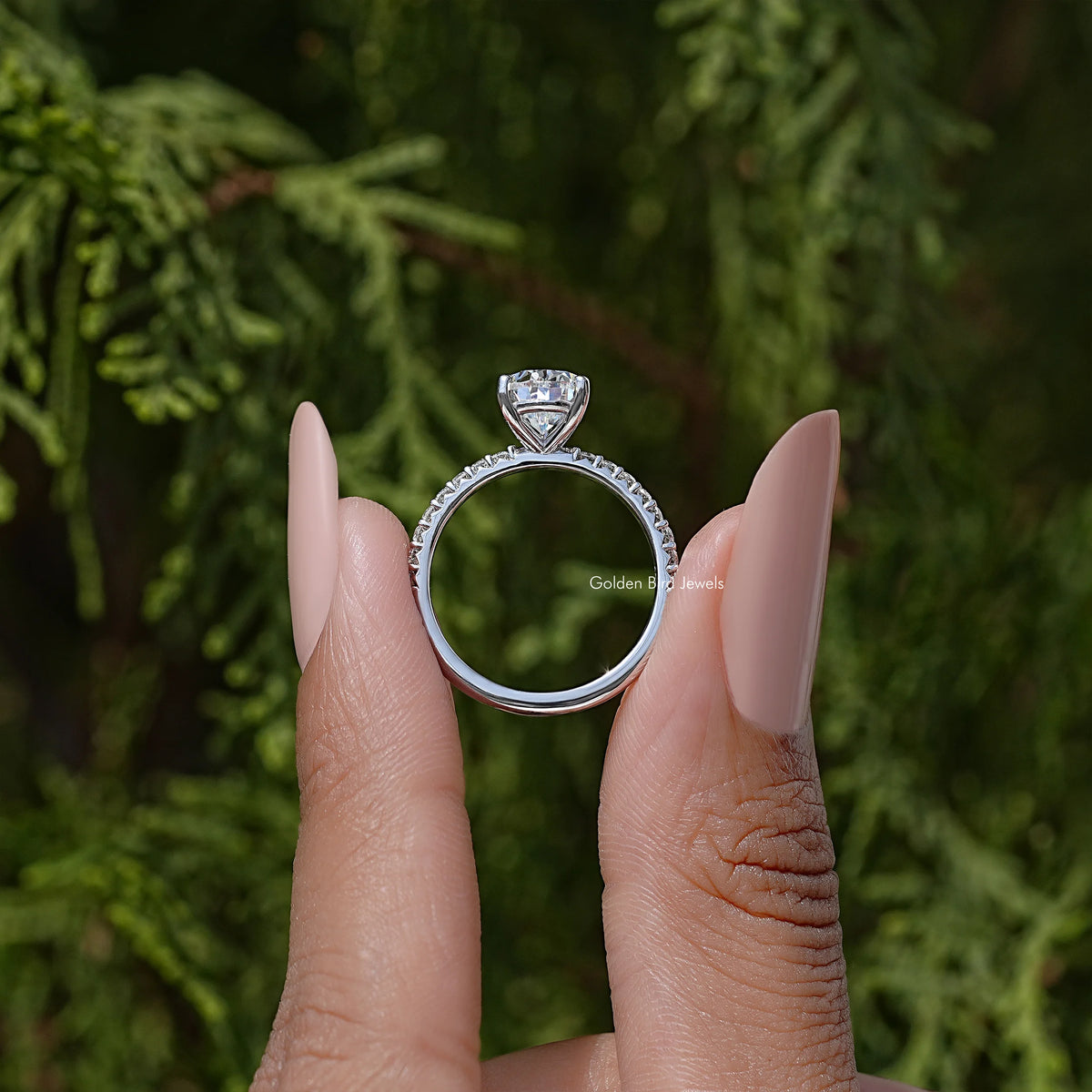 Sterling silver moissanite solitaire ring with pear-cut center and halo-like band