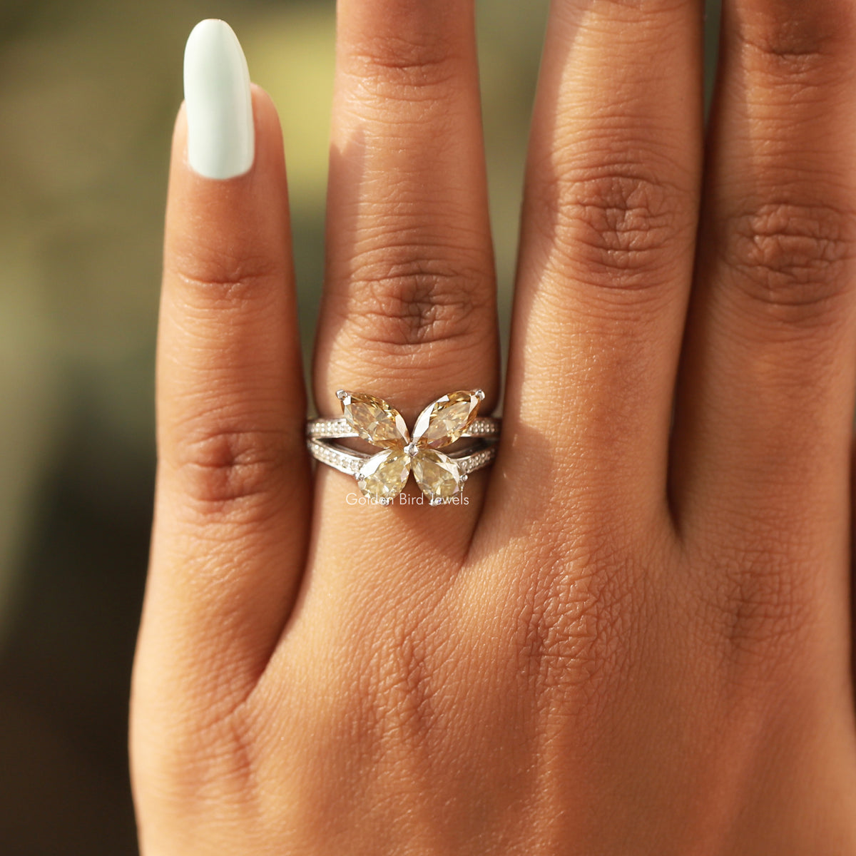 Silver-tone butterfly engagement ring with marquise-cut center stones and pave band
