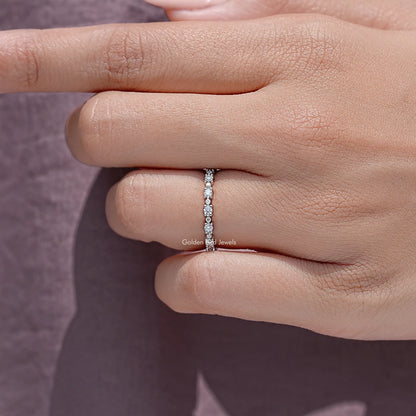 Silver round moissanite eternity band close-up showing a continuous stone row
