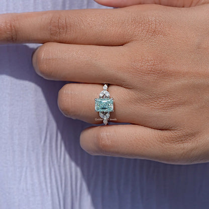 Sterling silver ring with cushion-cut blue-green moissanite and side stones