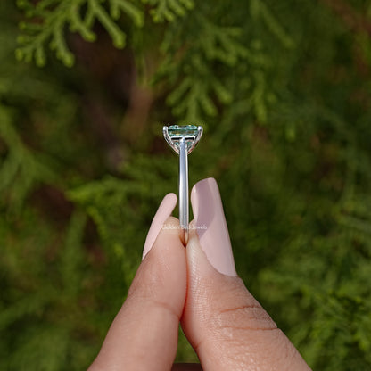Silver moissanite solitaire ring with square light-blue stone and three-prong setting