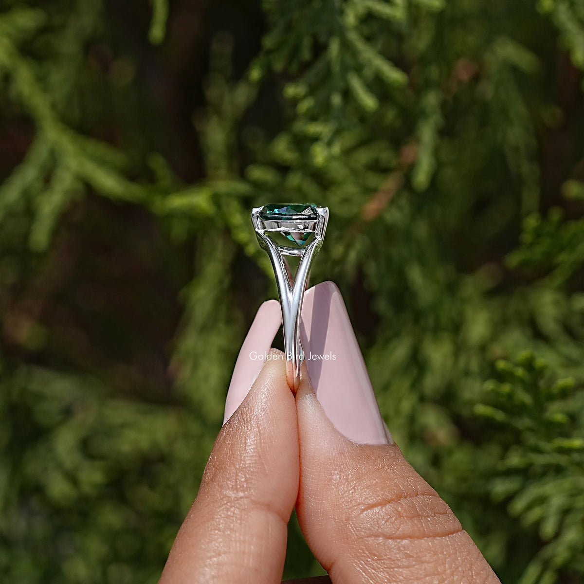 Heart-cut moissanite wedding ring with teal center stone, split shank prongs—close-up