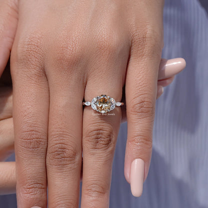 Moissanite oval center wedding ring with leaf side stones on hand, polished band