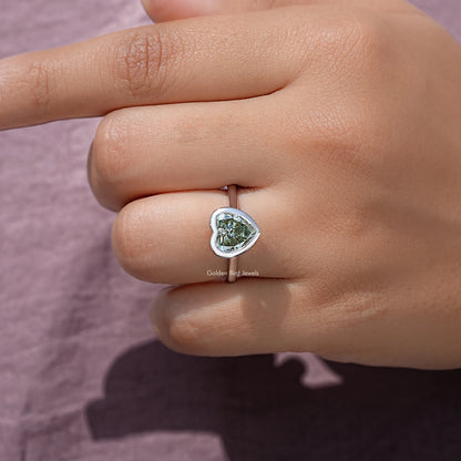 Heart-shaped moissanite bezel ring, close-up of heart stone on sterling band