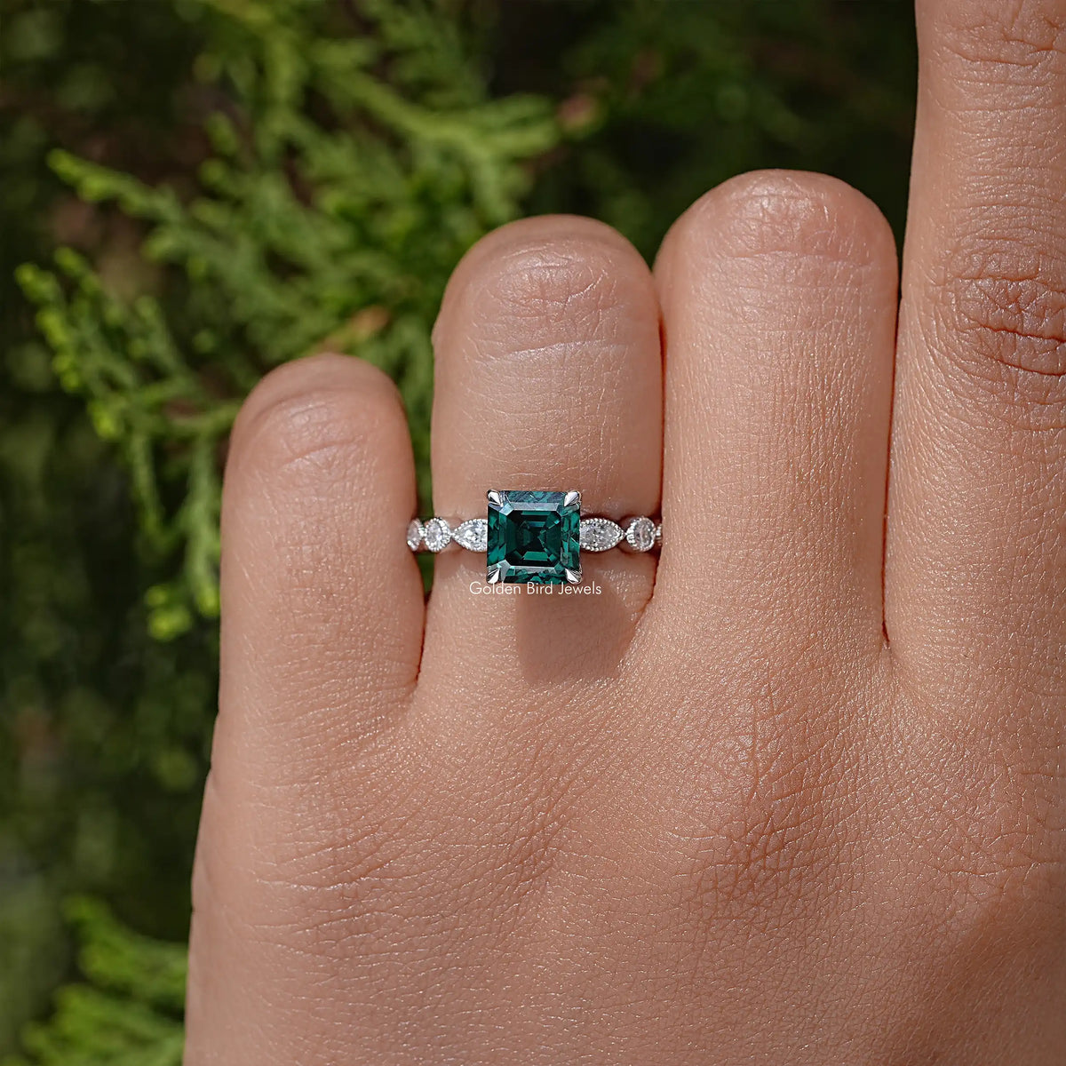 Green Asscher-cut moissanite ring with split prongs and small round side stones, silver