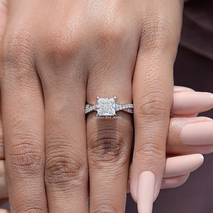 Close-up of sterling silver ring with princess-cut moissanite square center and side stones