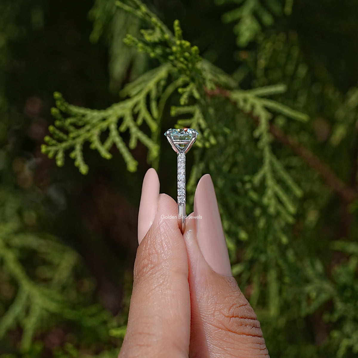Prong-set round-cut moissanite on sterling silver, side profile view