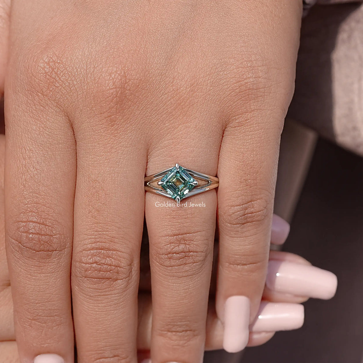 Teal Asscher cut moissanite split shank ring in sterling silver on hand