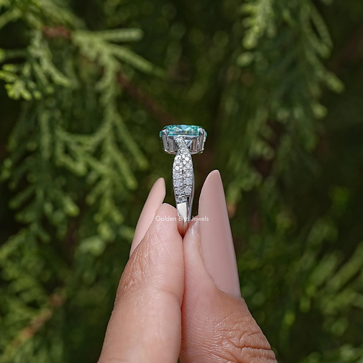 Sterling silver engagement ring with oval blue top stone and pave side panel