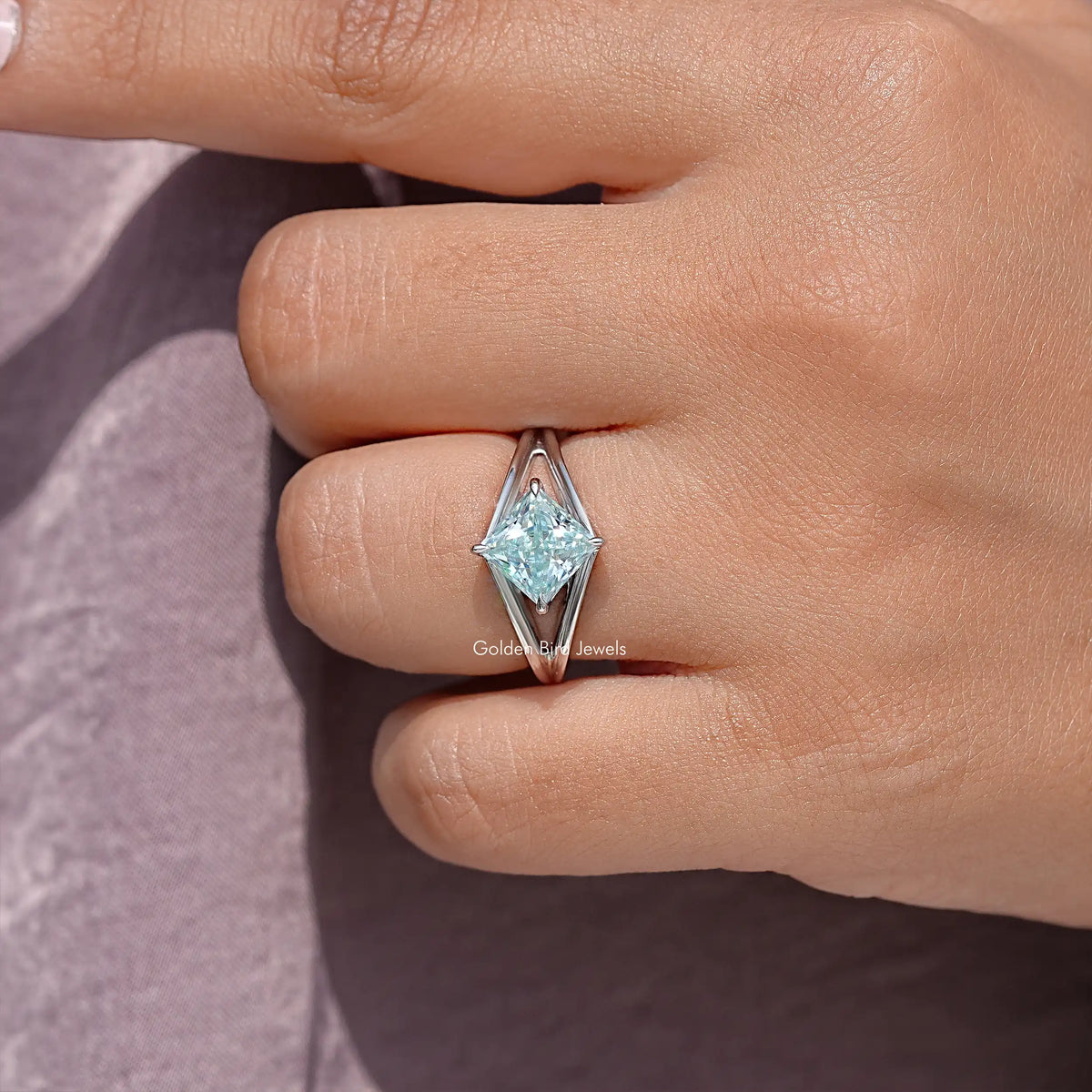 Sterling silver princess-cut moissanite ring, close-up of center stone and split shank