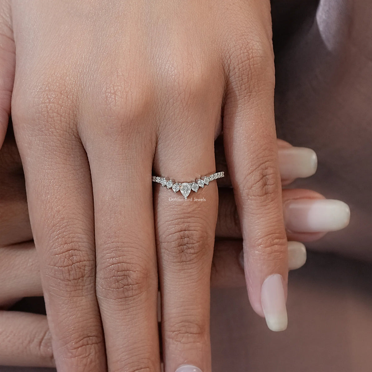 Silver moissanite eternity band ring with pear-cut white stones, on finger