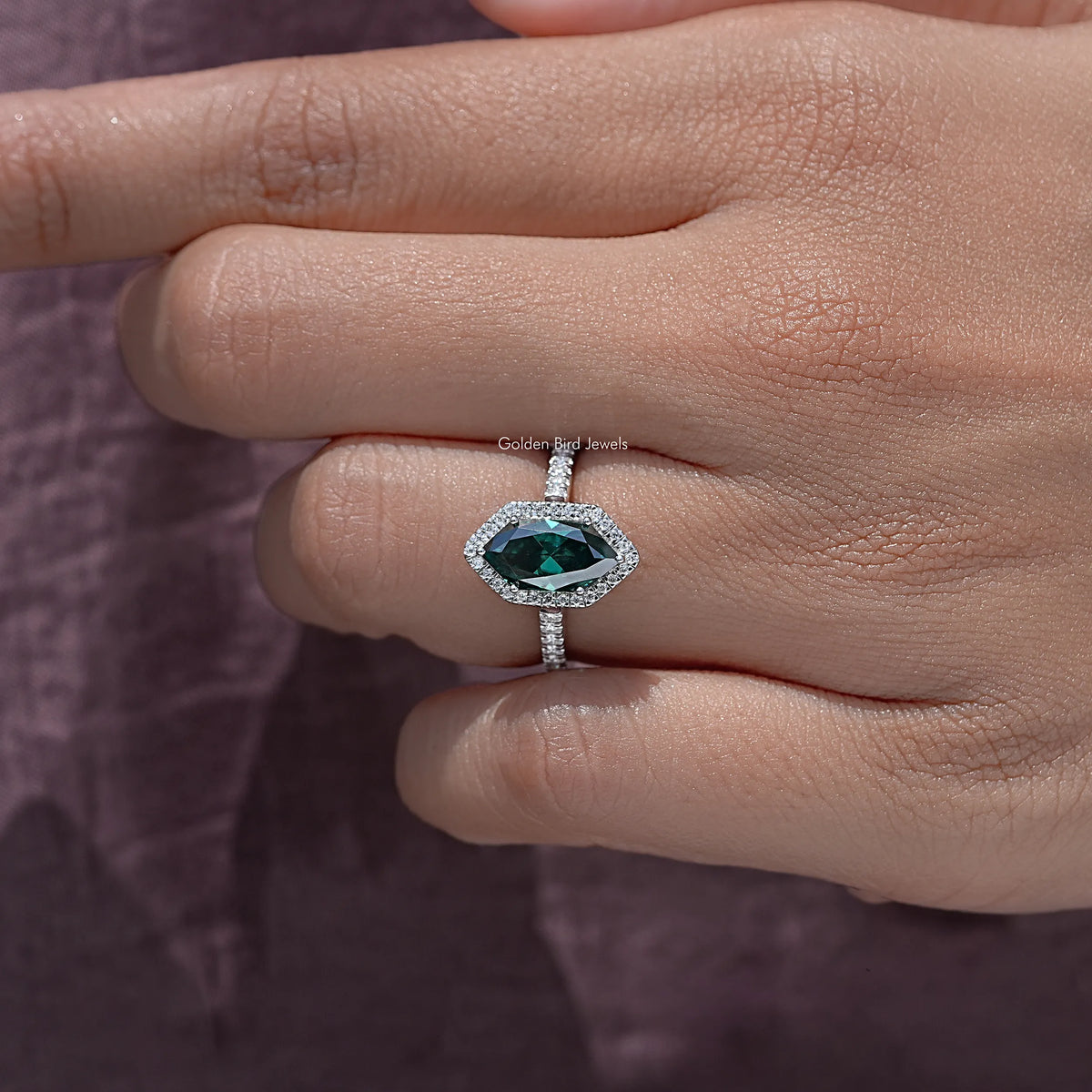 Sterling silver marquise halo accent ring on fingers, green marquise center stone