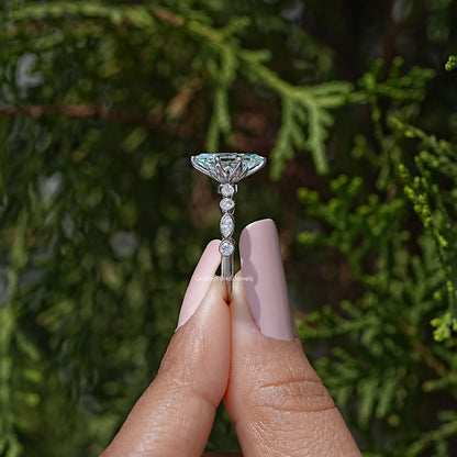 Sterling silver engagement ring with blue marquise center and vertical drop-like stones