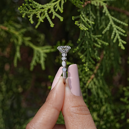 Side view of sterling silver oval moissanite ring with prong-set center and round stones