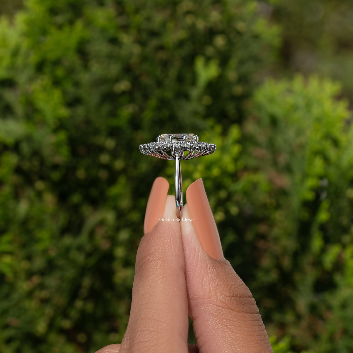 Oval moissanite halo ring in sterling silver, top view of prong-set halo