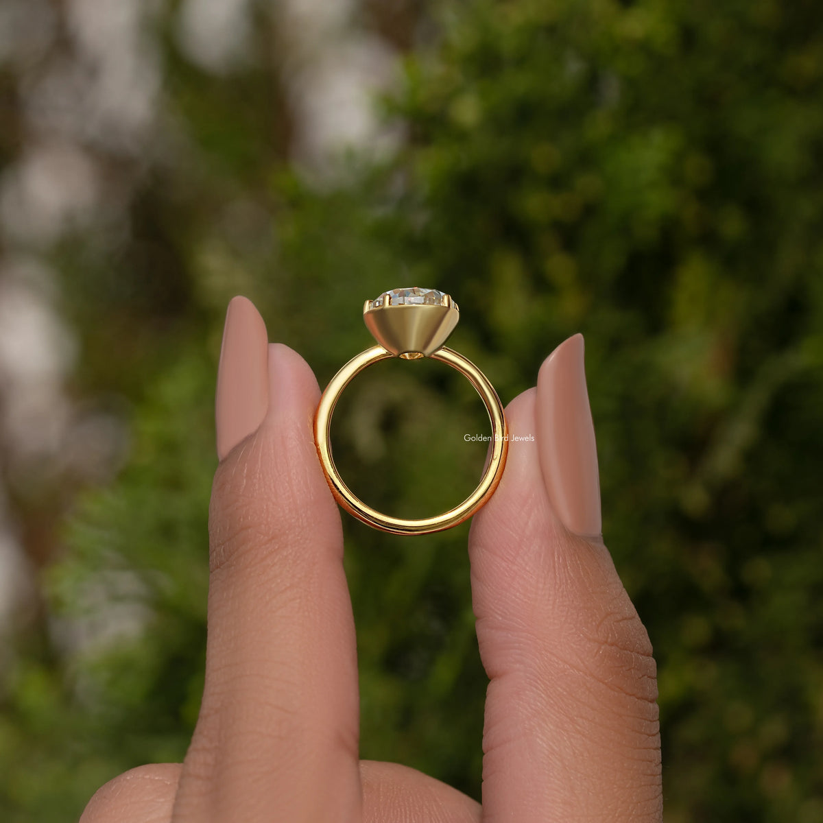 Gold-tone pear moissanite solitaire engagement ring with prong-set stone