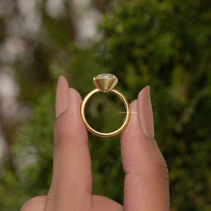Gold-tone pear moissanite solitaire engagement ring with prong-set stone