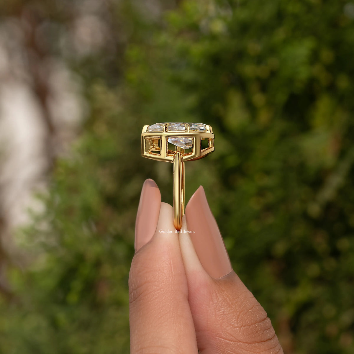 Side view of gold-tone solitaire ring showing stacked rectangular prongs