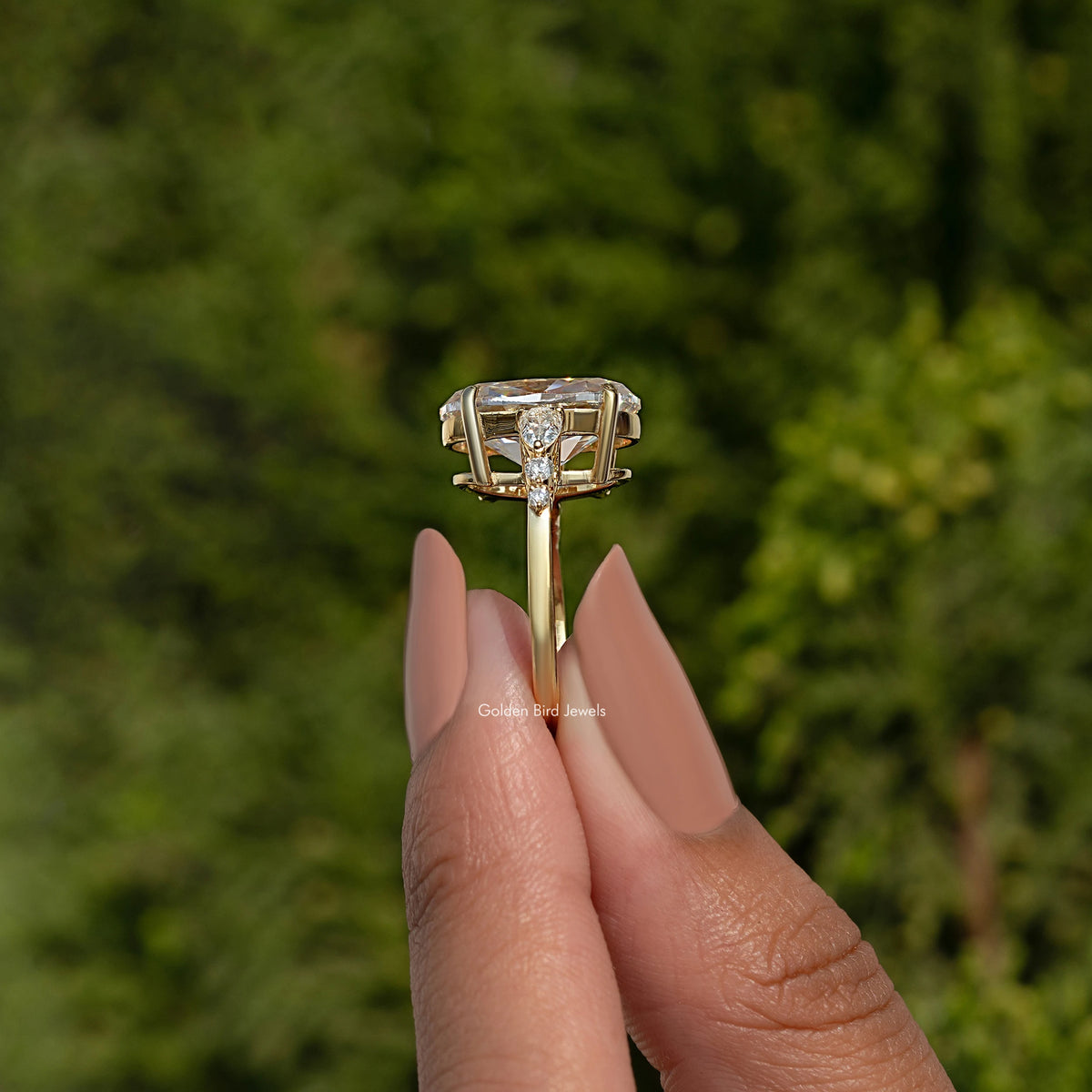 Oval moissanite cluster engagement ring, top view with raised center and prongs
