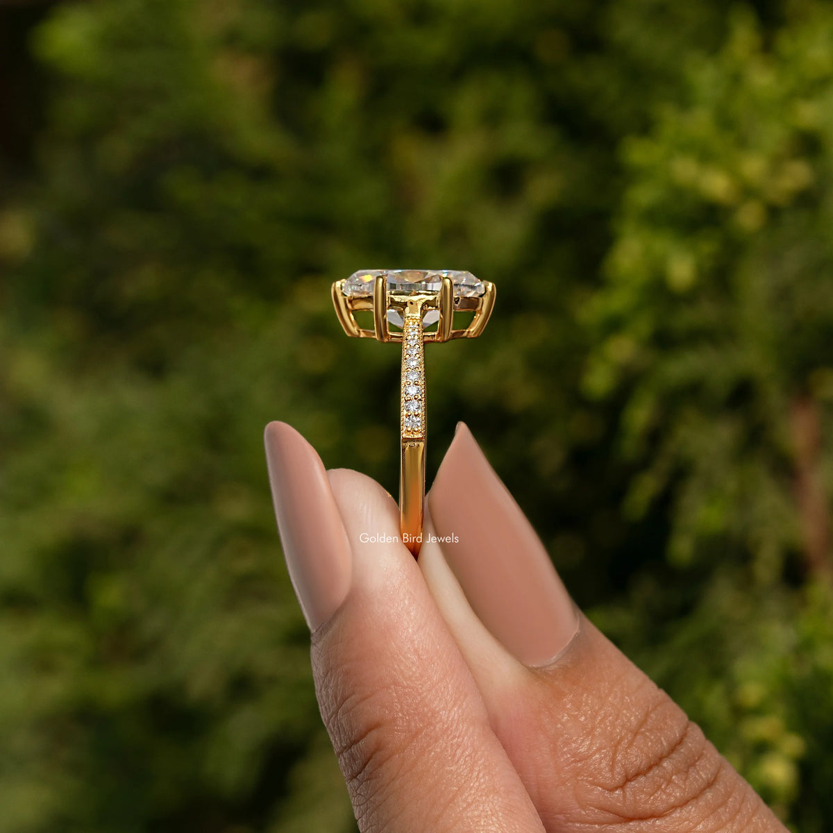 Oval-cut moissanite ring with pavé accent band, side view