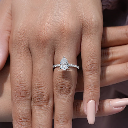 Sterling silver moissanite solitaire ring with pear-cut center and sparkling side stones