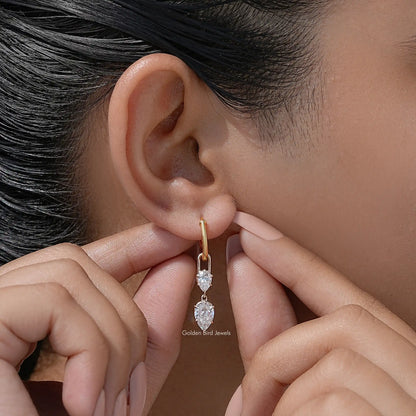Gold-tone hoop dangle earrings, two pear-cut clear stones shown close-up