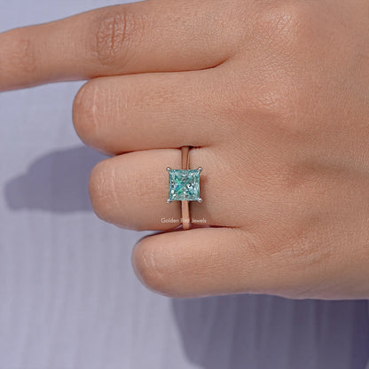 Moissanite solitaire ring with square light-blue princess-cut center stone on silver band