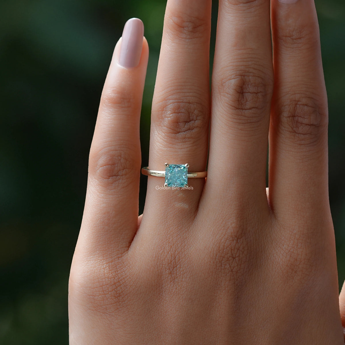 Silver princess-cut solitaire ring with cyan-blue square center stone