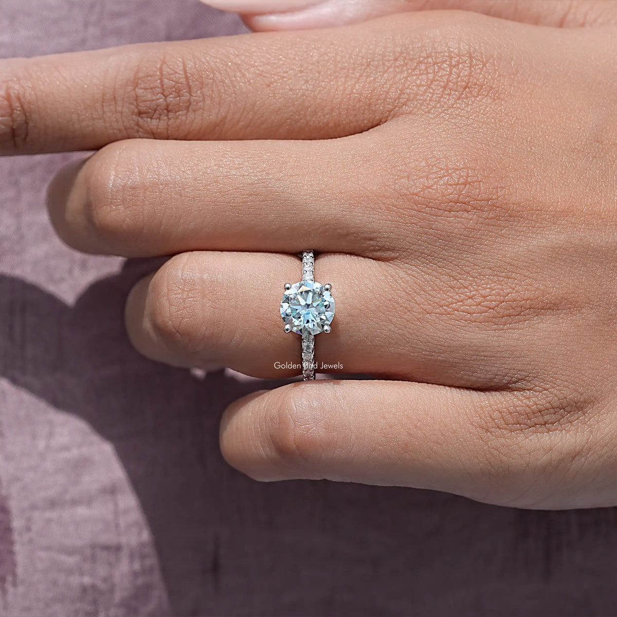 Round-cut moissanite solitaire on sterling silver band, front view