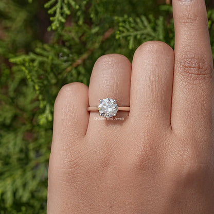 Sterling silver round moissanite solitaire ring, centered on hand, open band