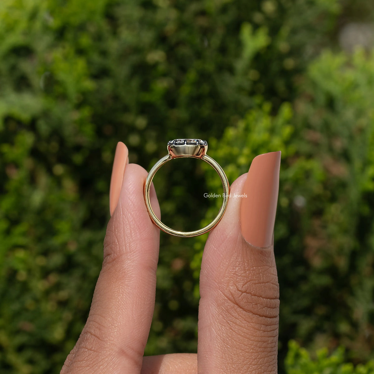 Gold oval-cut moissanite solitaire ring with four-prong basket