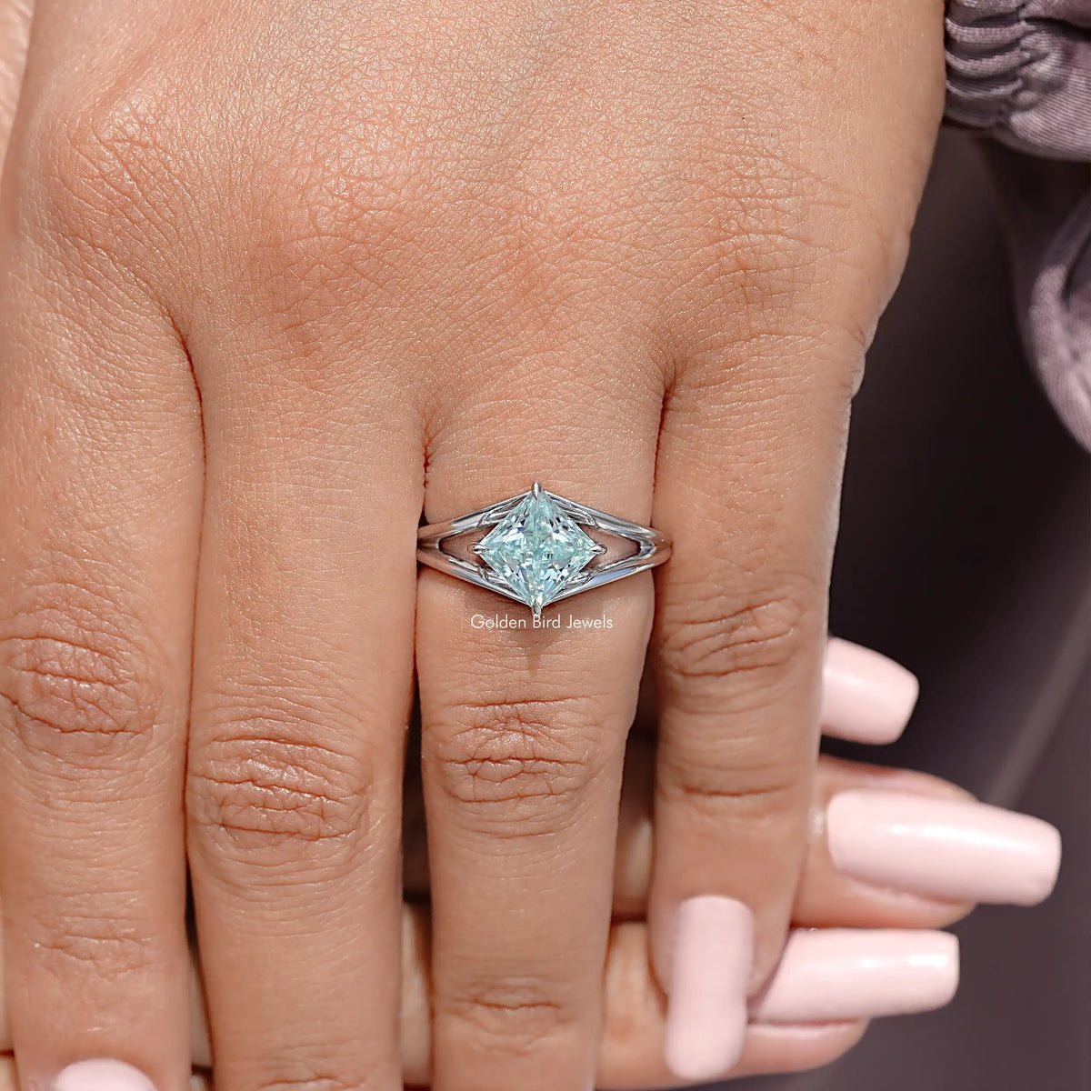 Sterling silver split-shank moissanite wedding ring on hand, front view
