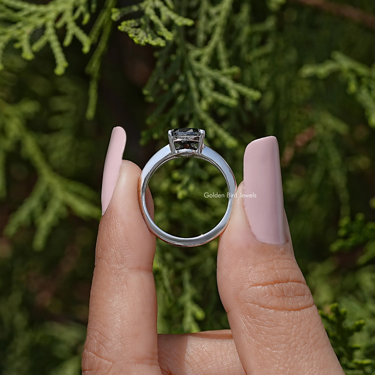 Back view of 925 sterling silver split-shank ring with prong-set pear-cut black moissanite