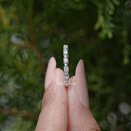 Silver eternity band side view with round moissanite stones in a vertical row