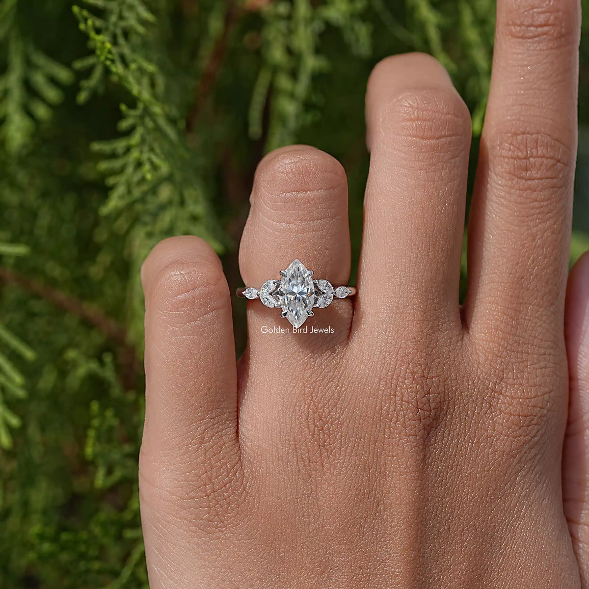 Marquise-cut moissanite diamond leaves ring on hand, marquise center with leaf accents