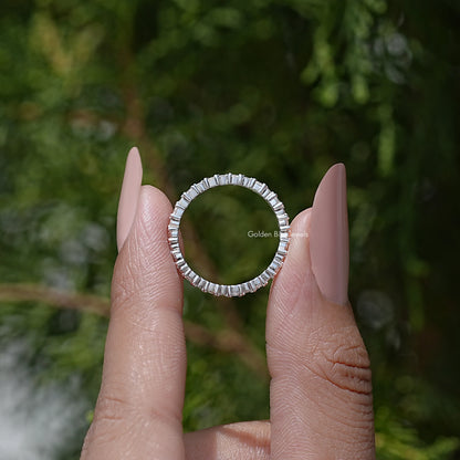 Silver eternity wedding band with round moissanite stones, arched side profile