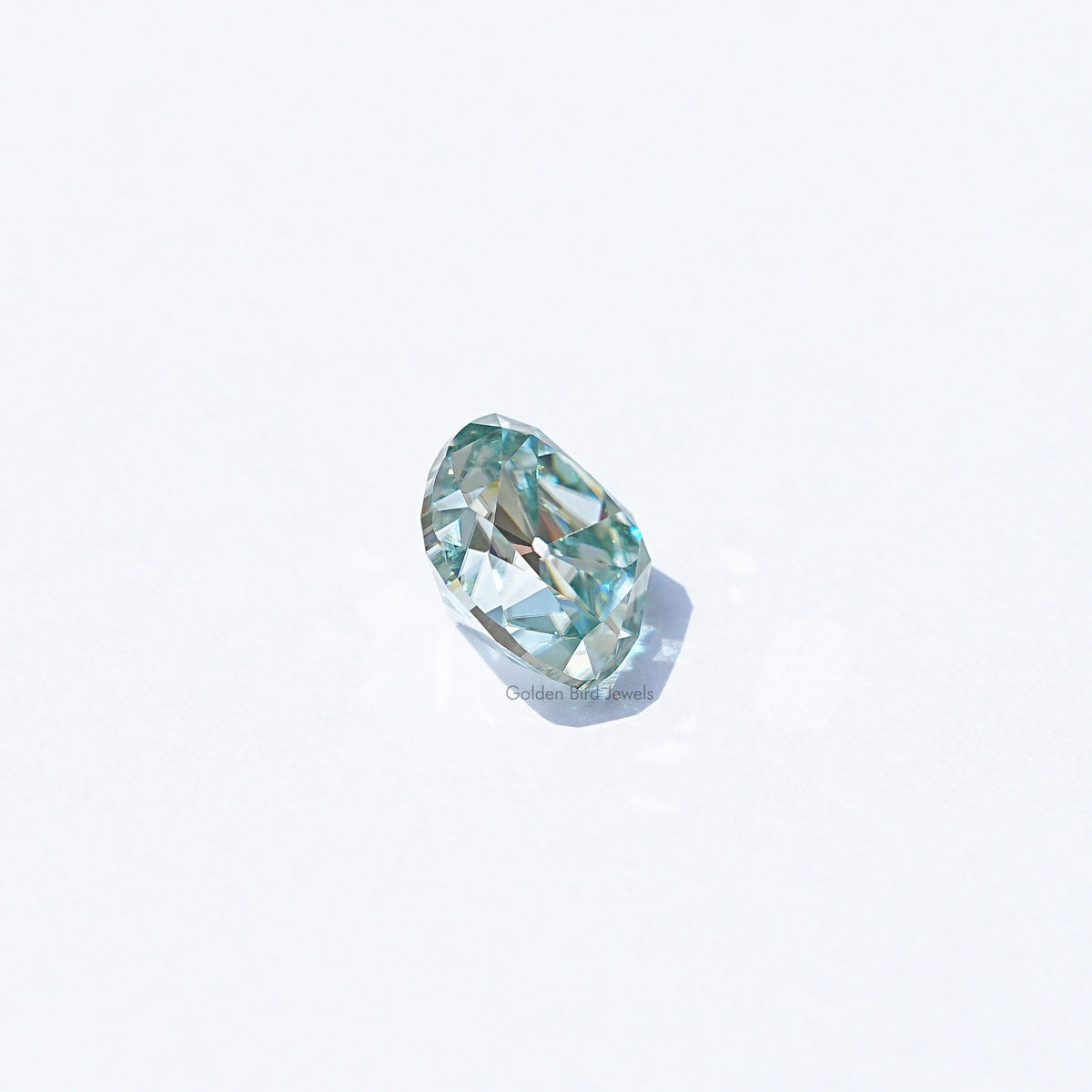 Light blue moissanite gemstone, cushion old mine cut, angled view