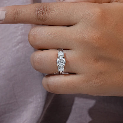 Three-stone round moissanite ring side view showing center stone and side stones