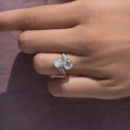 Cushion-cut diamond bypass ring on hand with baguette side stones
